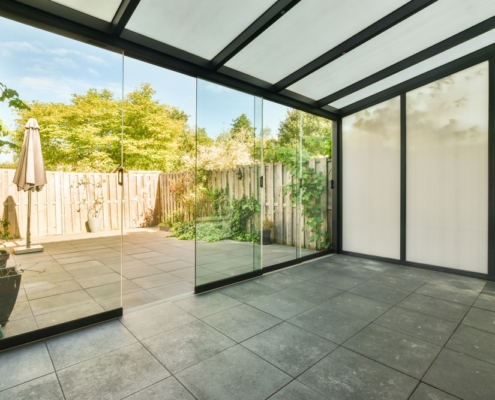 Bright living area in a Thailand home flooded with natural light through SUNFLEX premium glass sliding doors.