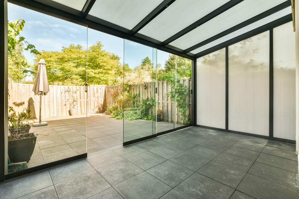 Bright living area in a Thailand home flooded with natural light through SUNFLEX premium glass sliding doors.