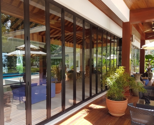 Commercial SF 45 folding sliding doors fully opened in a tropical resort restaurant.
