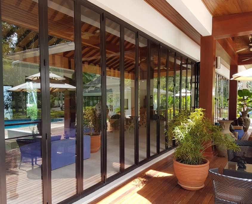 Commercial SF 45 folding sliding doors fully opened in a tropical resort restaurant.