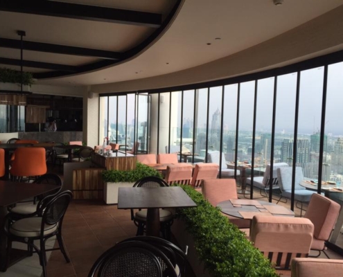 Corner installation of the SF 25 slide and turn glass panels in a restaurant lounge.