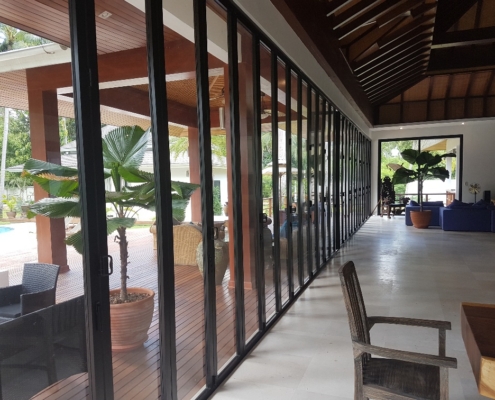 Close-up view of the stacked panels and flush floor track of the SF 45 commercial folding door system.