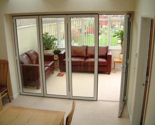 SF 45 aluminum folding system featuring an integrated pass-through swing door for easy daily access.