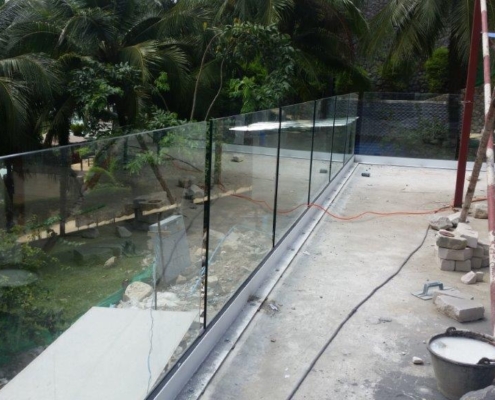 glass-balustrade-installation-base-tropical-forest Detail of the structural base for a frameless glass balustrade system on a tropical construction site in Thailand.