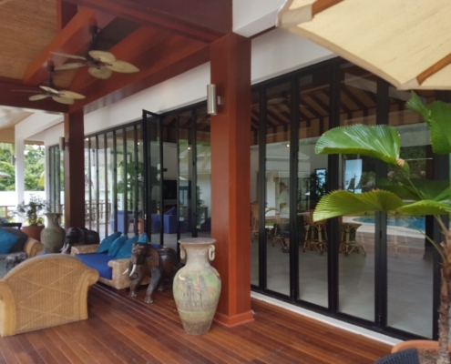 Heavy-duty aluminum bifold system by Sunflex installed in a hospitality dining area.