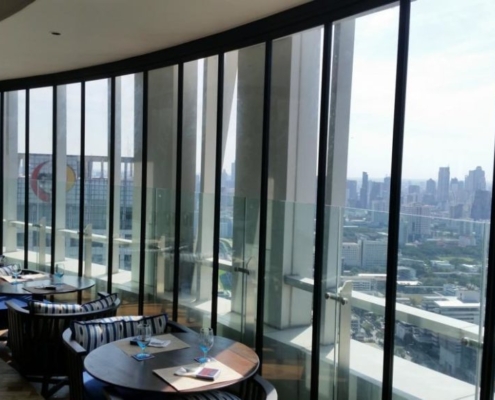 Framed SF 25 slide and turn glass wall maximizing natural light on a high-rise balcony.