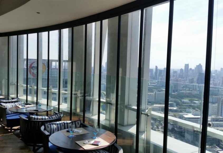 Framed SF 25 slide and turn glass wall maximizing natural light on a high-rise balcony.