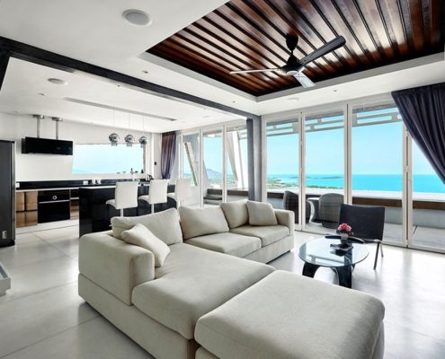 Large living space with the SF 45 folding glass system providing a seamless panoramic ocean view.