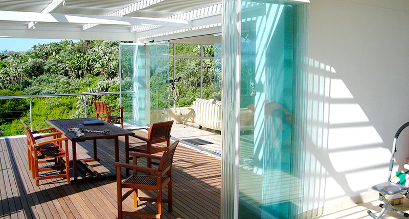 Sunflex SF 25 frameless all-glass slide and turn system for balcony glazing and terrace enclosures in Thailand with German engineering.