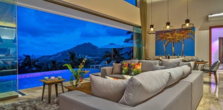 sunflex-sf20-all-glass-sliding-wall-dusk Sunflex SF 20 all-glass sliding wall in a tropical luxury villa at dusk