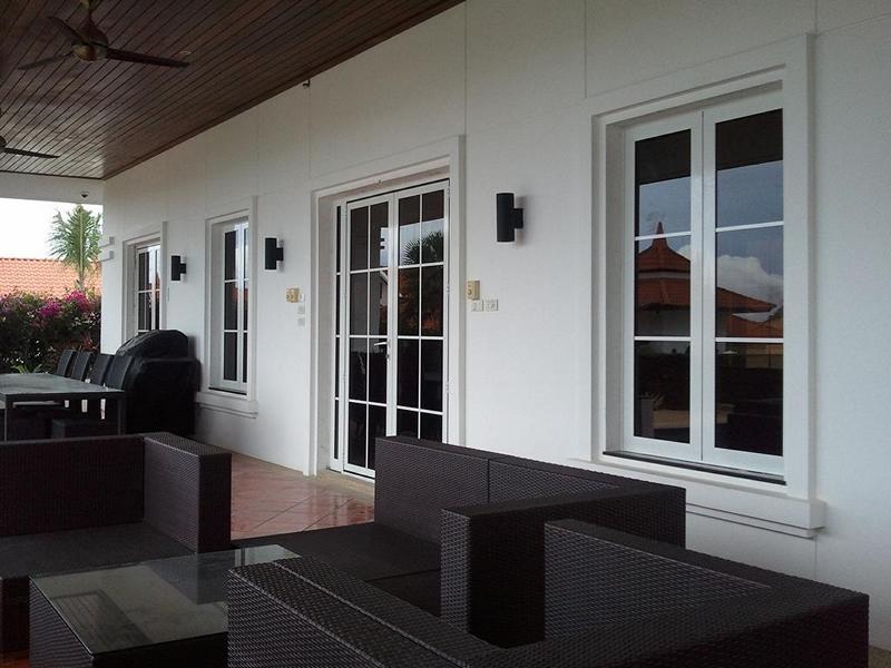 white-aluminum-french-doors-patio-sf45 White powder-coated SF 45 aluminum French doors and windows complementing a modern home exterior.